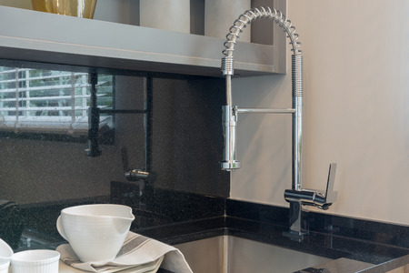 modern kitchen room with sink on top granite counter, interior designの写真素材