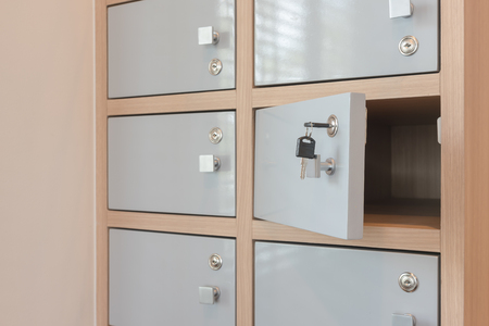Key hanging from the locker doors opening, wooden locker interior designの写真素材