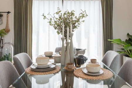 glass dining table with table set in modern dining room interior design conceptの写真素材