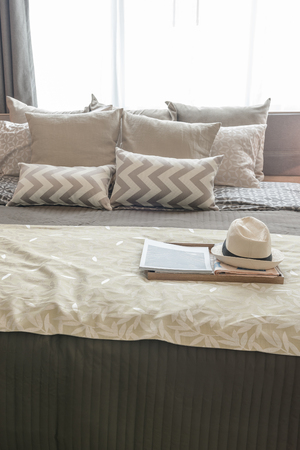 set of pillows on bed in cozy bedroom interior designの写真素材