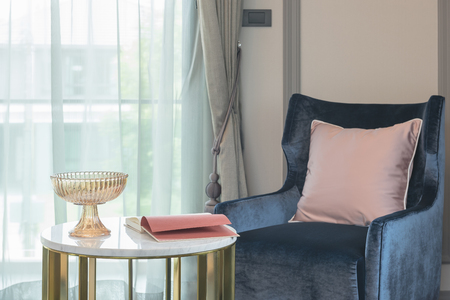 blue sofa with pink pillow and round table in living room, interior designの写真素材