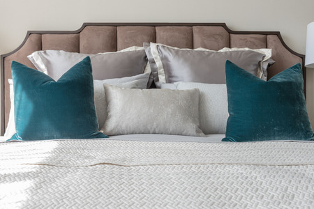 classic bedroom style with set of pillows and lamp on table side, interior design concept