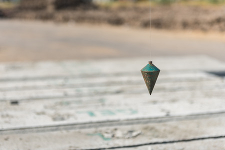 old metal plumb line used in construction site