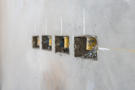 electrical socket hole on precat concret wall, outlet electric wires in constuction siteの写真素材