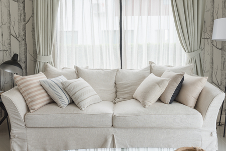 set of pillows on white classic sofa in living room, interior design conceptの写真素材