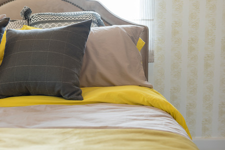classic bedroom style with set of pillows on bed, interior design concept