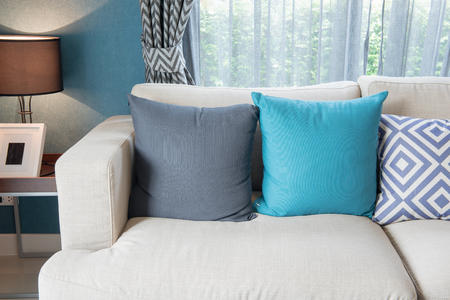 colorful pillows on modern sofa in modern living room, interior design conceptの写真素材