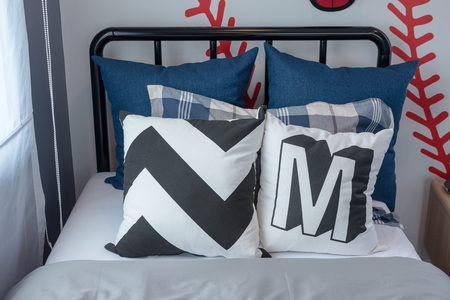 set of blue and white pillows on bed in modern single bedroom, interior design conceptの写真素材