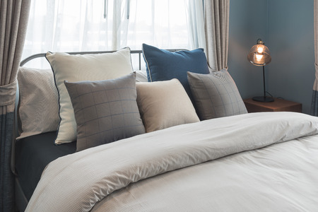 set of pillows on bed in modern bedroom style, interior design conceptの写真素材