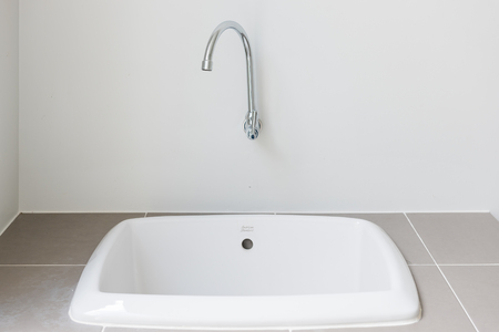 modern sink on counter with faucet in wall, interior design conceptの写真素材