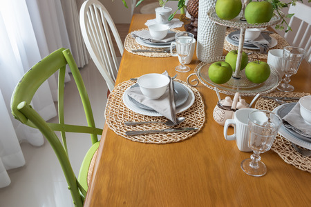 modern table set on wooden dining table in modern dining room, interior design concept