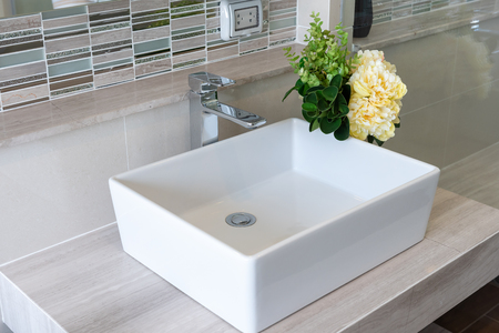 Bathroom interior in new luxury home, sink with faucet and decoration set, white washbasin and faucetの写真素材
