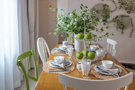 modern table set on wooden dining table in modern dining room, interior design concept