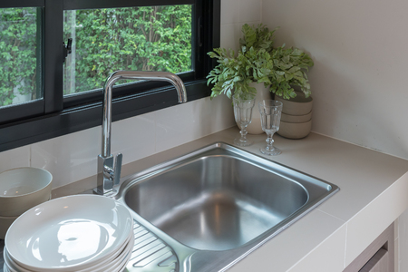 sink with faucet in kitchen room, modern counter with sink in kitchen room, interior design conceptの写真素材