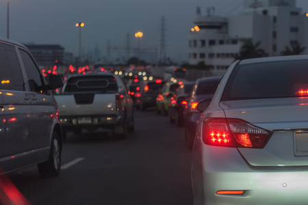 traffic jam on main street with row of cars in downtown, central businees distric before nightの写真素材