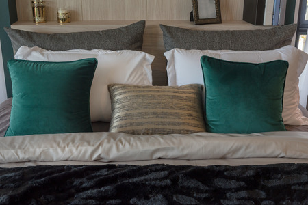modern bedroom with set of pillows on classic bed, interior decoration design conceptの写真素材
