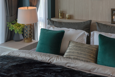 modern bedroom with set of pillows on classic bed, interior decoration design conceptの写真素材