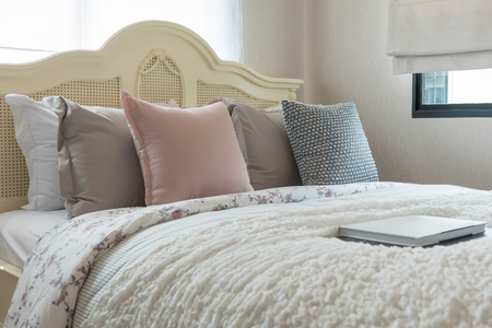 classic bedroom style with set of pillows on bed and classic lamp in white color tone, interior design decoration conceptの写真素材