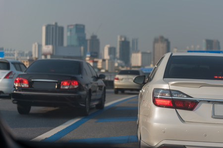 traffic jam on main street with row of cars in downtown, central businees districの写真素材