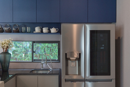 interior design of new decorated wooden kitchen in luxury home with black granite counter topの写真素材