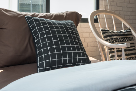 black and white pillows set on single bed in modern bedroom, interior decoration design conceptの写真素材