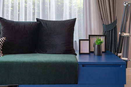 modern living room in blue color tone with set of pillows on modern sofa, interior design decorTIONの写真素材