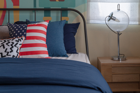 colorful pillows on blue bed in modern bedroom, interior deisgn decoration conceptの写真素材