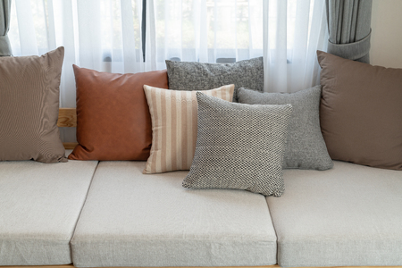 modern living room with set of pillows on sofa, interior design concept decorationの写真素材