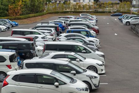 row of cars parked in outdoor parking lot, out door parking with lot of carsの写真素材