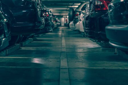 dark undergrond parking lot with full of cars, vintage style processの写真素材