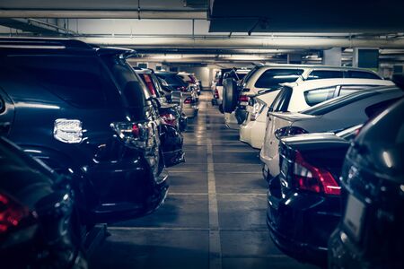 dark undergrond parking lot with full of cars, vintage style process