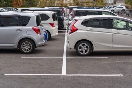 row of cars parked in outdoor parking lot, out door parking with lot of carsの写真素材