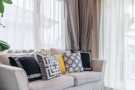 modern living room with modern white sofa and set of pillows, interior design decoration concept