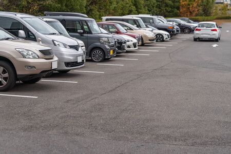 row of cars parked in outdoor parking lot, out door parking with lot of carsの写真素材