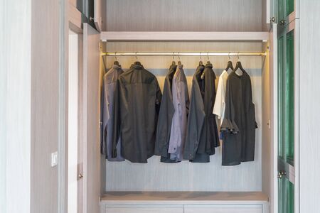modern wardorbe with set of clothes hanging on rail, modern closet interior design conceptの写真素材