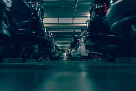 dark undergrond parking lot with full of cars, vintage style processの写真素材