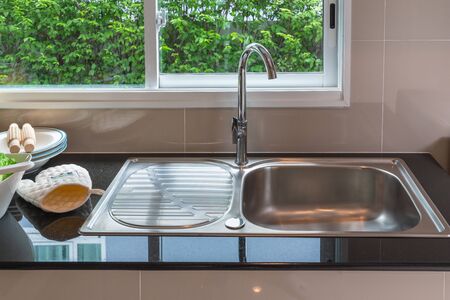 modern kitchen room with sink on black counter, interior design decoration conceptの写真素材