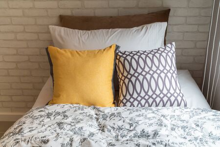 modern bedroom with set of pillows on bed, interior design concept decoration