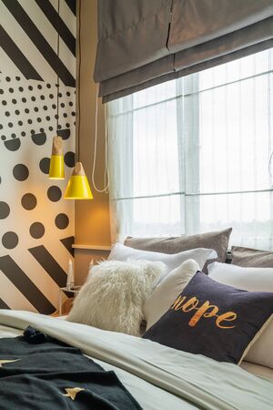 modern bedroom with set of pillows on bed, interior design concept decoration