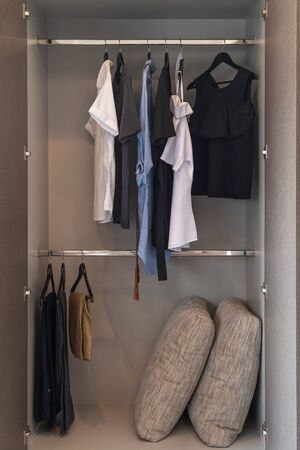 modern wardrobe with set of clothes hanging on rail, modern closet interior design conceptの写真素材