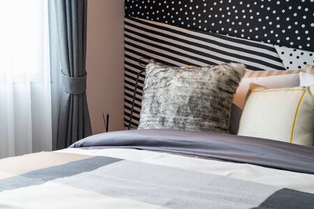 modern bedroom with set of pillows on bed, interior design concept decorationの写真素材