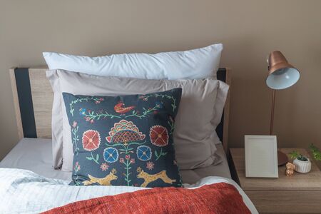 modern bedroom with set of pillows and cushions on bed, interior design concept decorationの写真素材