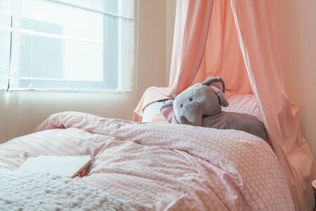 pink color tone kid's bedroom with doll, interior design decoration conceptの写真素材