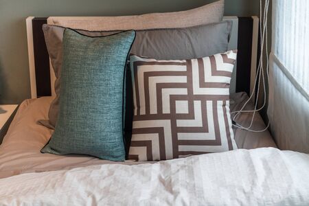 modern bedroom with set of green pillows on bed, interior design concept decorationの写真素材