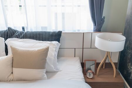modern bedroom with set of pillows and cushions on bed, interior design concept decorationの写真素材