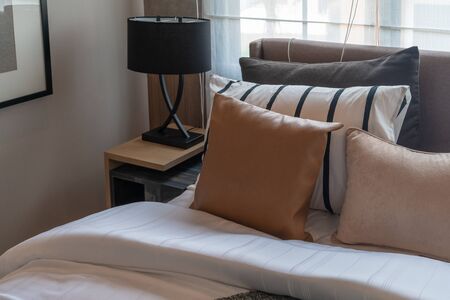 modern bedroom with set of pillows and cushions on bed, interior design concept decorationの写真素材