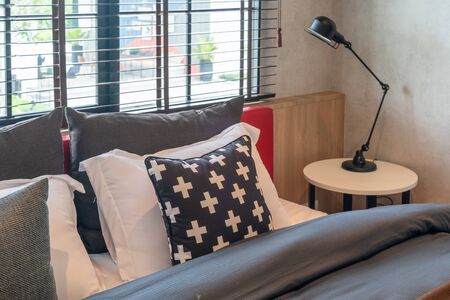 modern bedroom with set of pillows on bed, interior design concept decorationの写真素材