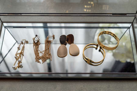 collection of women's accessories in glass display shelves at home, fashion blogger's collection, interior design decorationの写真素材