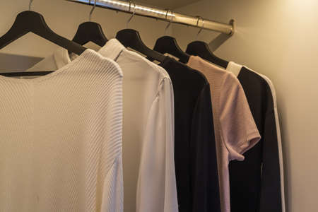 modern wardorbe with set of clothes hanging on rail, modern closet interior design concept