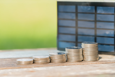 Solar panel, photovoltaic, alternative electricity source - selective focus, copy space with coin...